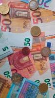 Rotating stack of Euro banknotes and coins as background video