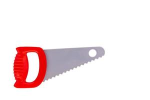 Saw, a toy hacksaw with a red handle on a white isolated background. photo