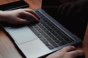 Closeup image of hands typing on laptop. Business and finance concept. Technology keyboard with copy space. photo