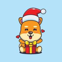 lindo perro shiba inu feliz con regalo de navidad. linda ilustración de dibujos animados de navidad. vector