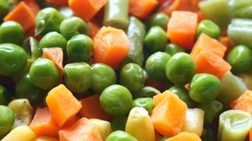 Peas carrots green beans and corn in rotating close up video