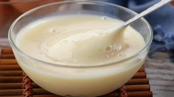 Pouring condensed milk in a bowl video