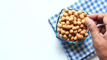 Adult takes Crunchy Soy Coated Roasted Chickpeas out of bowl for snacking video