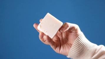 Hand holding a squared soap bar video