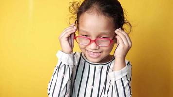 Little girl with glasses smiling video