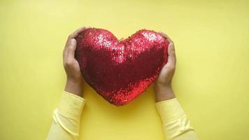 Hands holding a heart shaped object video