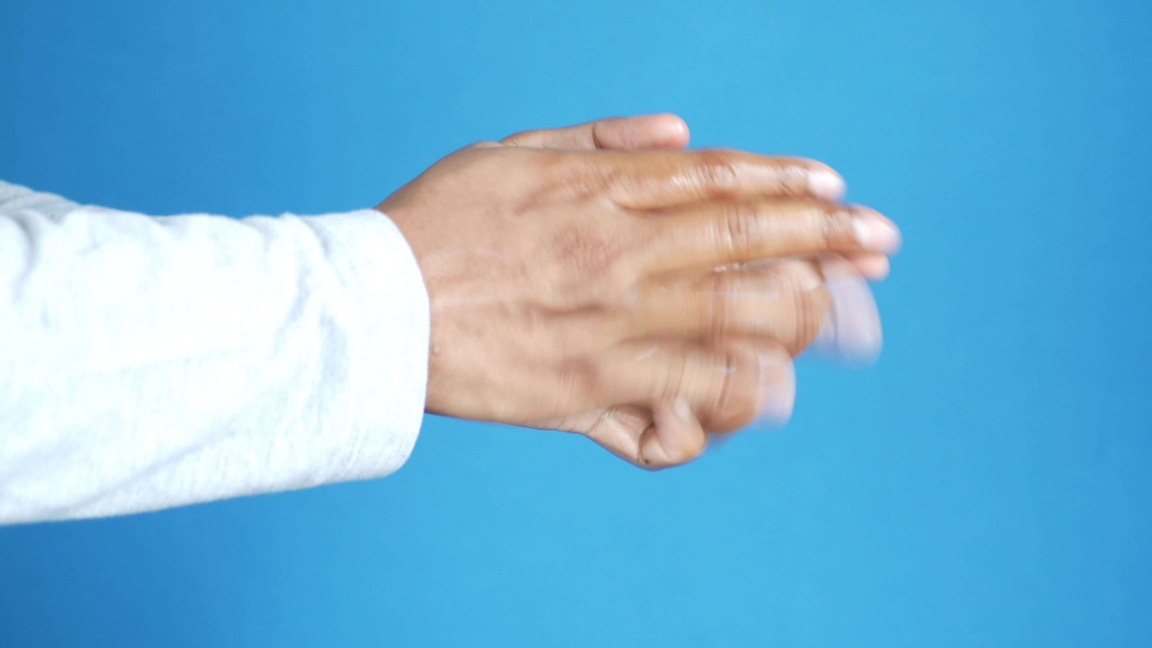 Man rubbing hands together with blue background 13792436 Stock Video at
