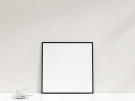 Interior poster mockup with photo frame leaning against the white wall. Minimalist photo frame mockup. Empty frame stands on white table. 3d rendering.