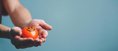 Hands holding and giving red heart for love, health care, organ donation, world heart day, world health day, mindfulness, well being, family insurance concept. photo