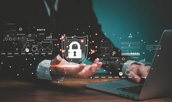 Internet network security, Business man using laptop computer and holding cyber security lock icons. photo
