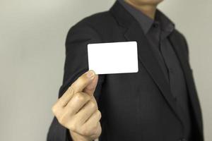Business Man holding white ID card, A smart man holding white mock up inter card, used for poster concept designs. photo