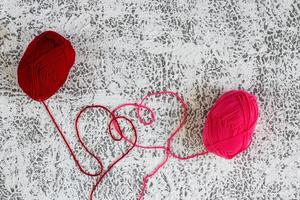 Red yarn with love text on gray texture background. Happy valentine concept. photo