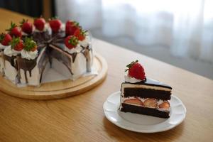 Chocolate cake with strawberry and whipping cream. Homemade bekery concept. photo