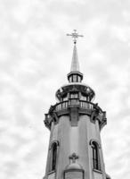 Christian church cross in high steeple tower for prayer photo