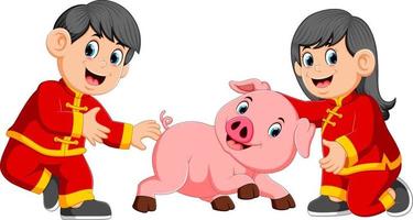 two kids are playing with a little pig in chinese new year vector