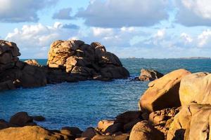 Pink granit in blue sea photo