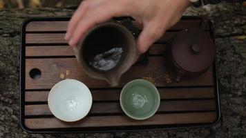 man's hand pours dark pu-erh tea video