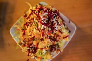 Cheese corn nachos served on a big plate ready to eat photo