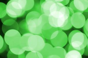 Green abstract Christmas blurred luminous background. Defocused artistic bokeh lights image photo