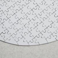 A white jigsaw puzzle in the complete form lies on a treated stone surface. Textured image with copy space photo
