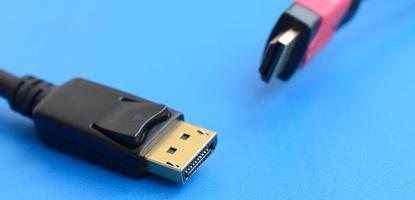 Audio video HDMI computer cable plug and 20-pin male DisplayPort gold plated connector for a flawless connection on a blue background photo
