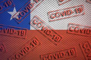 Chile flag and many red Covid-19 stamps. Coronavirus or 2019-nCov virus concept photo