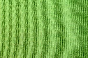 The texture of the fabric is bright green. Material for making shirts and blouses photo