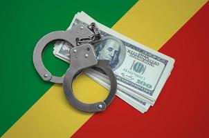 Congo flag with handcuffs and a bundle of dollars. Currency corruption in the country. Financial crimes photo