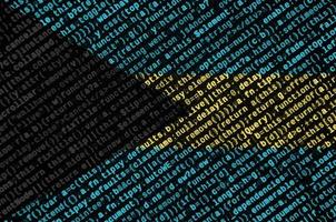 Bahamas flag is depicted on the screen with the program code. The concept of modern technology and site development photo