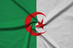 Algeria flag is depicted on a sports cloth fabric with many folds. Sport team banner photo