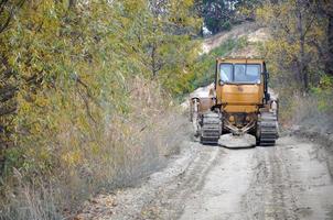 Quarry aggregate with heavy duty machinery. Caterpillar loader Excavator with backhoe driving to construction site quarry photo
