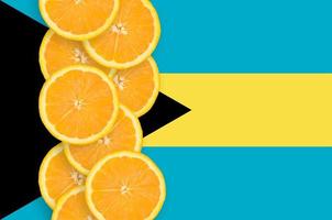 Bahamas flag and citrus fruit slices vertical row photo