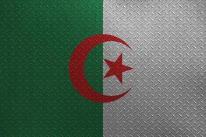 Algeria flag depicted in paint colors on old brushed metal plate or wall closeup. Textured banner on rough background photo