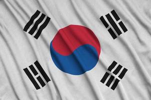 South Korea flag is depicted on a sports cloth fabric with many folds. Sport team banner photo