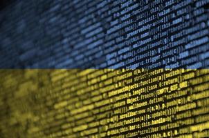 Ukraine flag is depicted on the screen with the program code. The concept of modern technology and site development photo