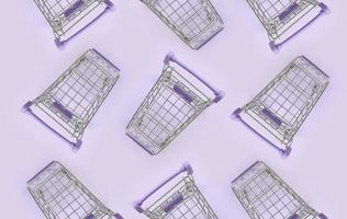Pattern of many small shopping carts on a violet background. Minimalism flat lay top view photo