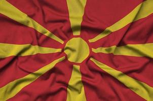 Macedonia flag is depicted on a sports cloth fabric with many folds. Sport team banner photo