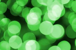 Green abstract Christmas blurred luminous background. Defocused artistic bokeh lights image photo