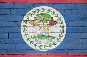 Belize flag is painted onto an old brick wall photo