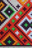 Traditional Ukrainian folk art knitted embroidery pattern on textile fabric photo