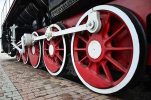 Red wheels of steam train photo