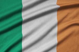 Ireland flag is depicted on a sports cloth fabric with many folds. Sport team banner photo