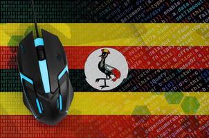 Uganda flag and computer mouse. Digital threat, illegal actions on the Internet photo