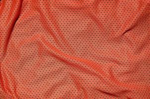 Close up of red polyester nylon sportswear shorts to created a textured background photo