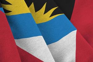 Antigua and Barbuda flag with big folds waving close up under the studio light indoors. The official symbols and colors in banner photo