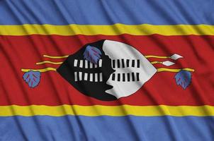 Swaziland flag is depicted on a sports cloth fabric with many folds. Sport team banner photo