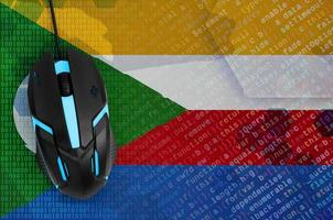 Comoros flag and computer mouse. Digital threat, illegal actions on the Internet photo