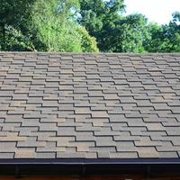 Modern roofing and decoration of chimneys. Flexible bitumen or slate shingles photo