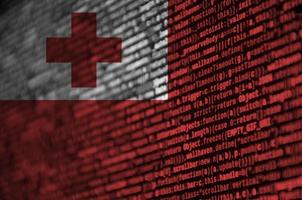 Tonga flag is depicted on the screen with the program code. The concept of modern technology and site development photo