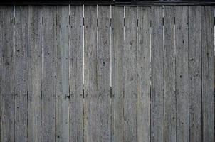 The texture of an old rustic wooden fence made of flat processed boards photo